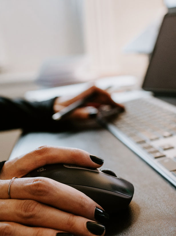 Photo of hands working with a mouse and a keyboard